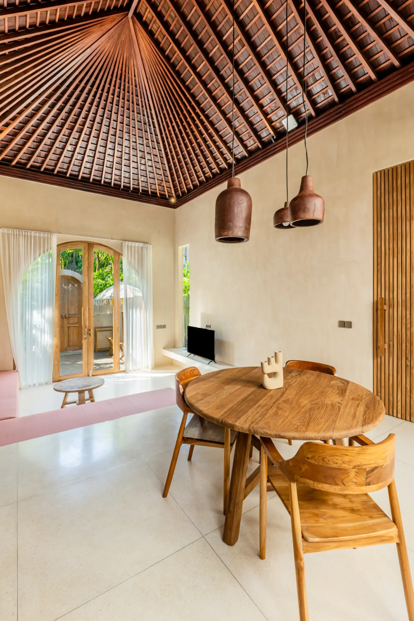 Interior dining area with wooden ceiling and modern furnishings