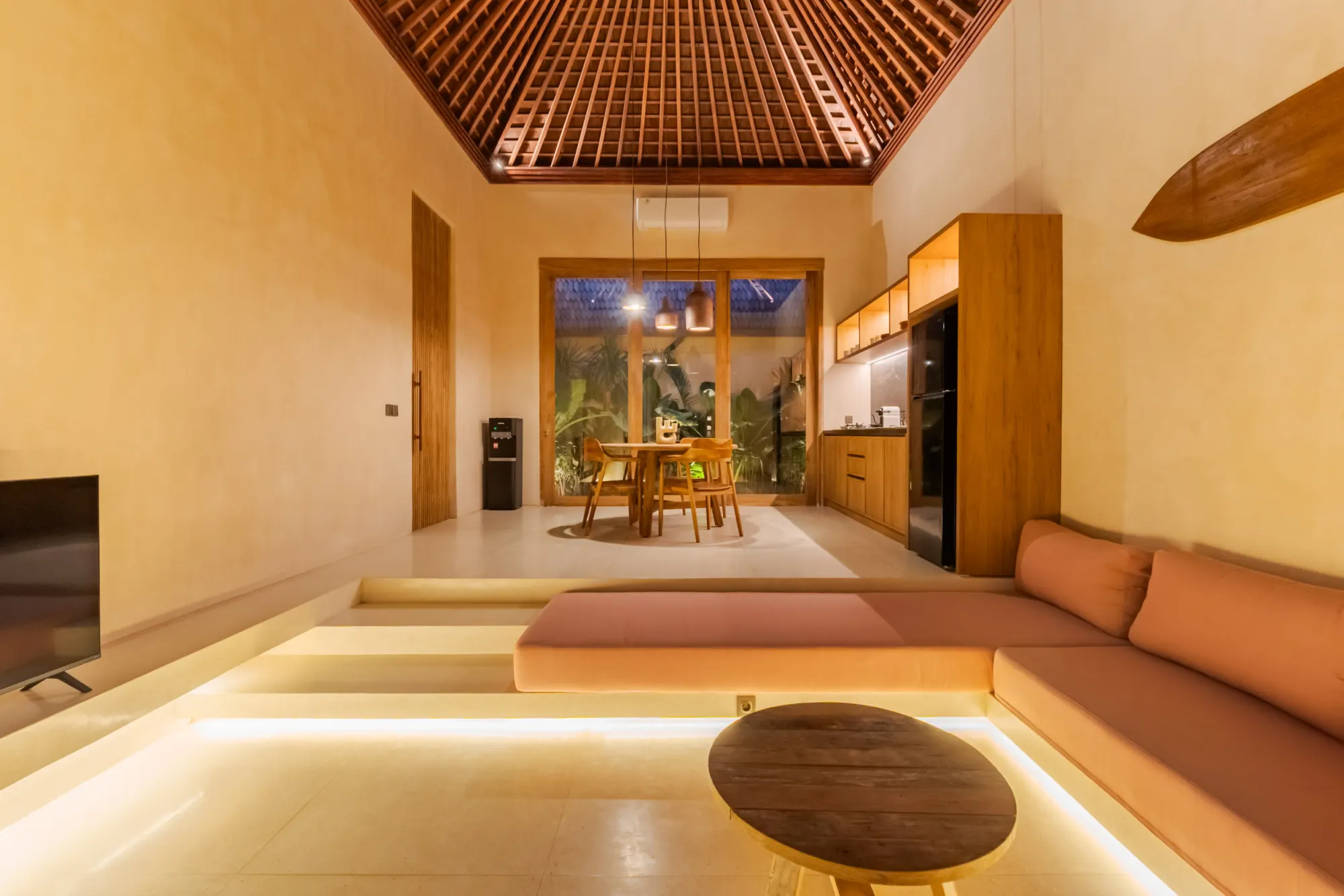 Interior living space with coffered ceiling, sofa and open layout