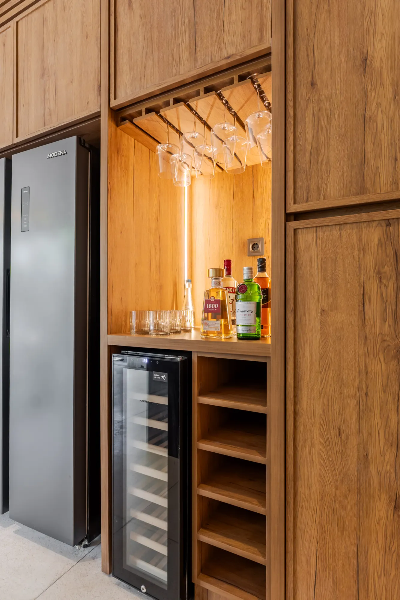 Wooden bar area with wine cooler and bottle display