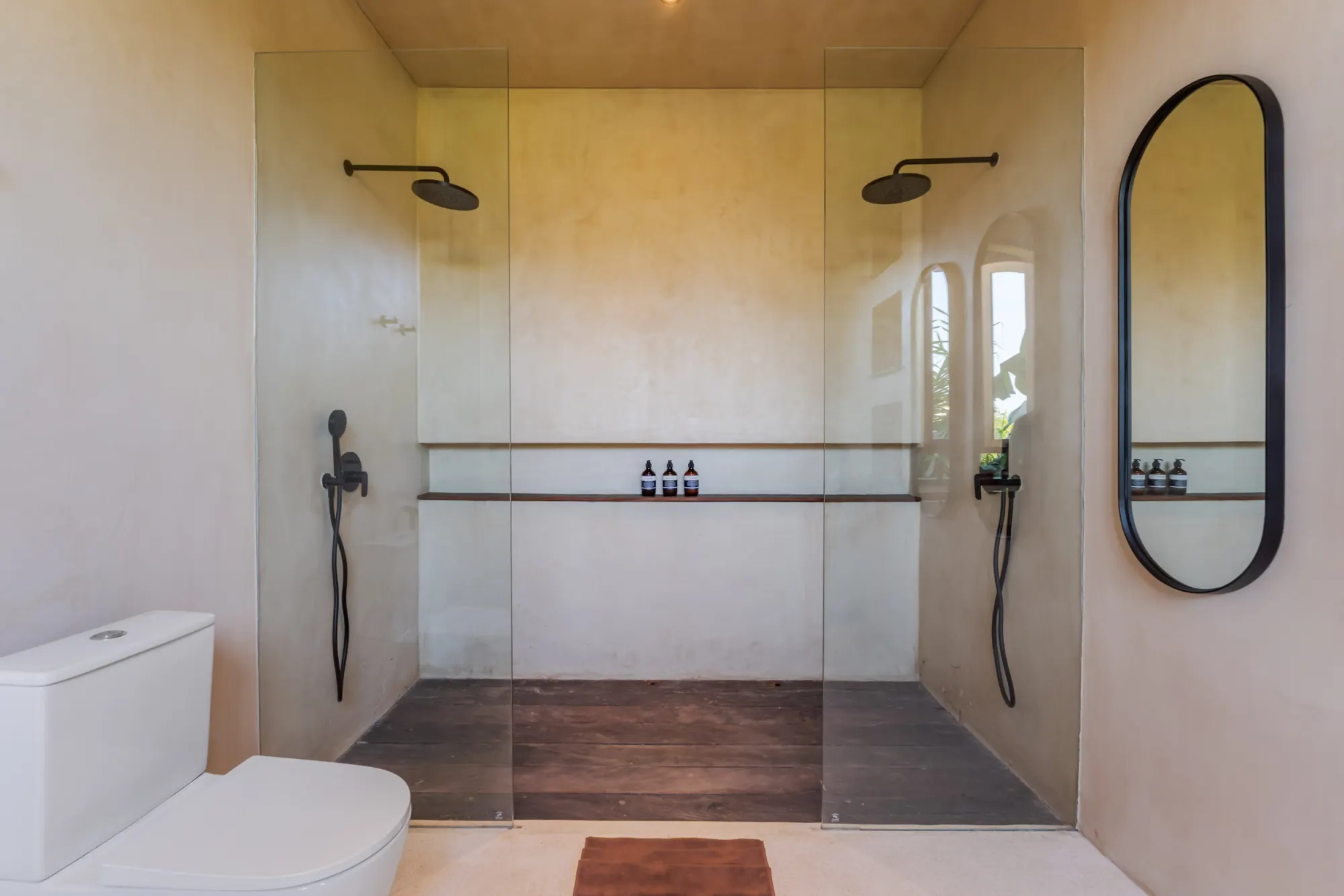 Luxurious dual shower with rainfall heads and heated shelf