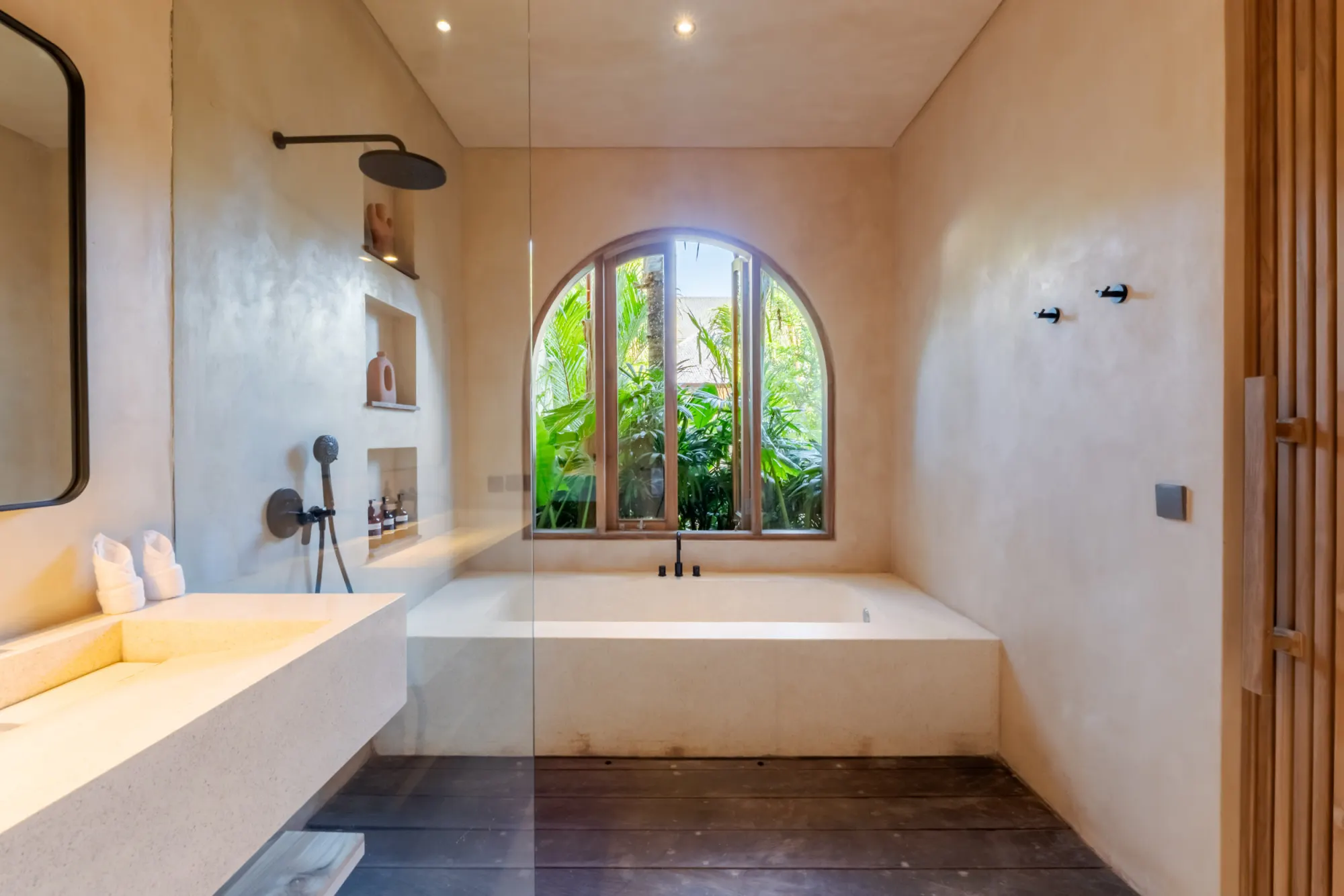 Spa-inspired soaking tub with garden views and stone accents