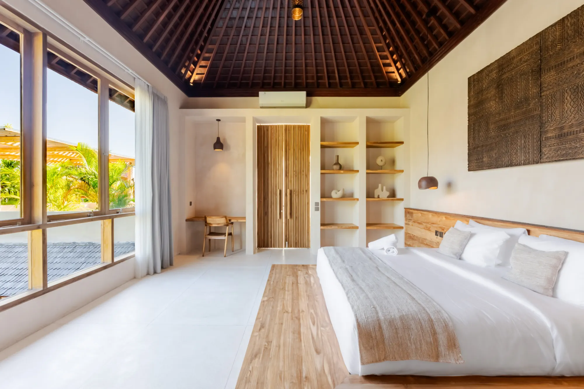 Master bedroom with wooden ceiling and garden landscape