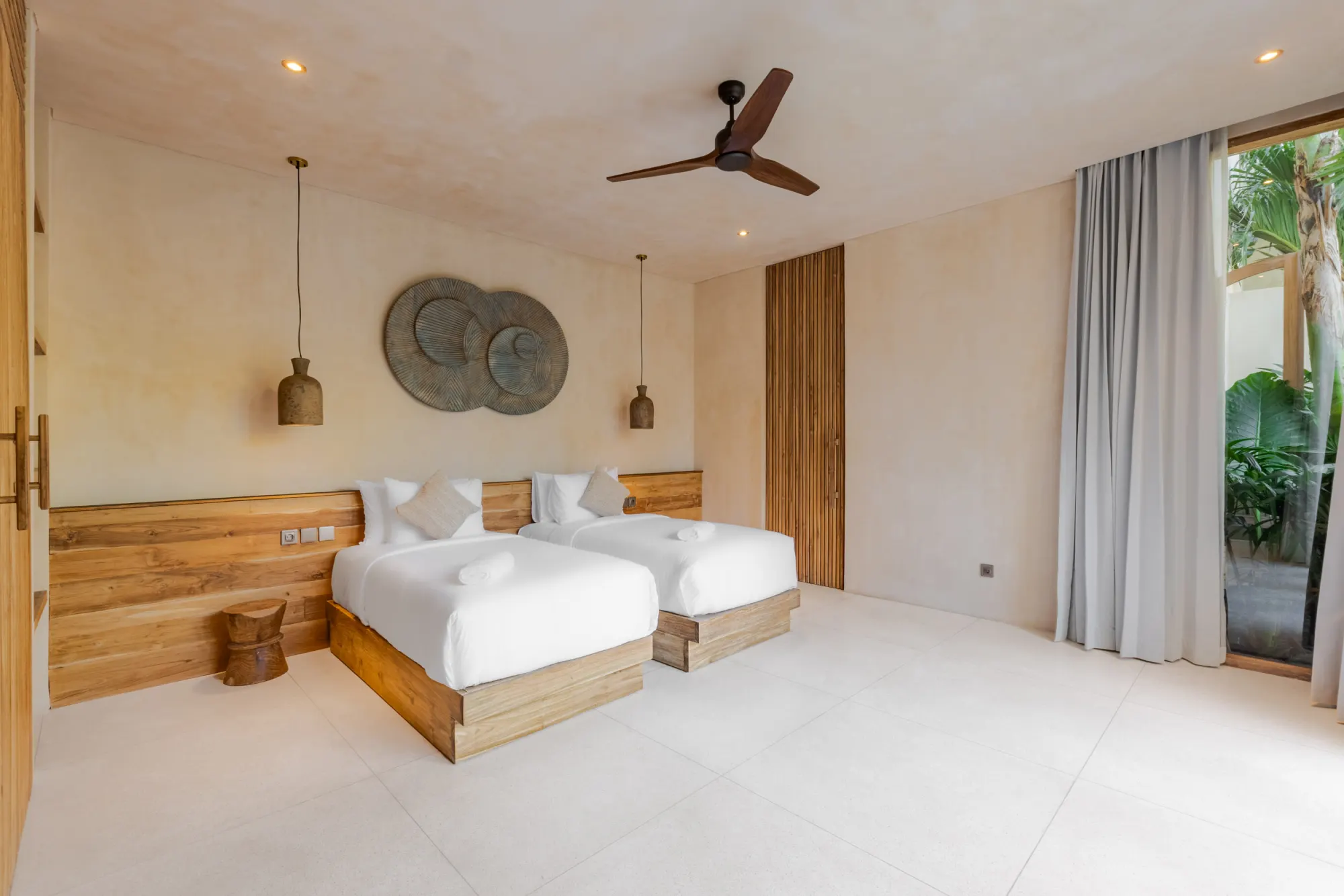 Twin-bed room with sliding glass doors to garden patio
