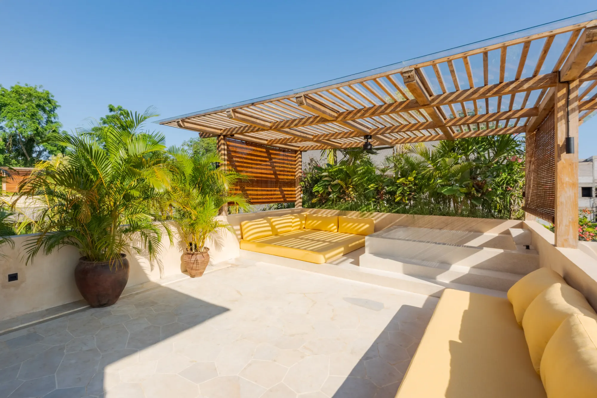 Pool deck with loungers, umbrella, and garden surround