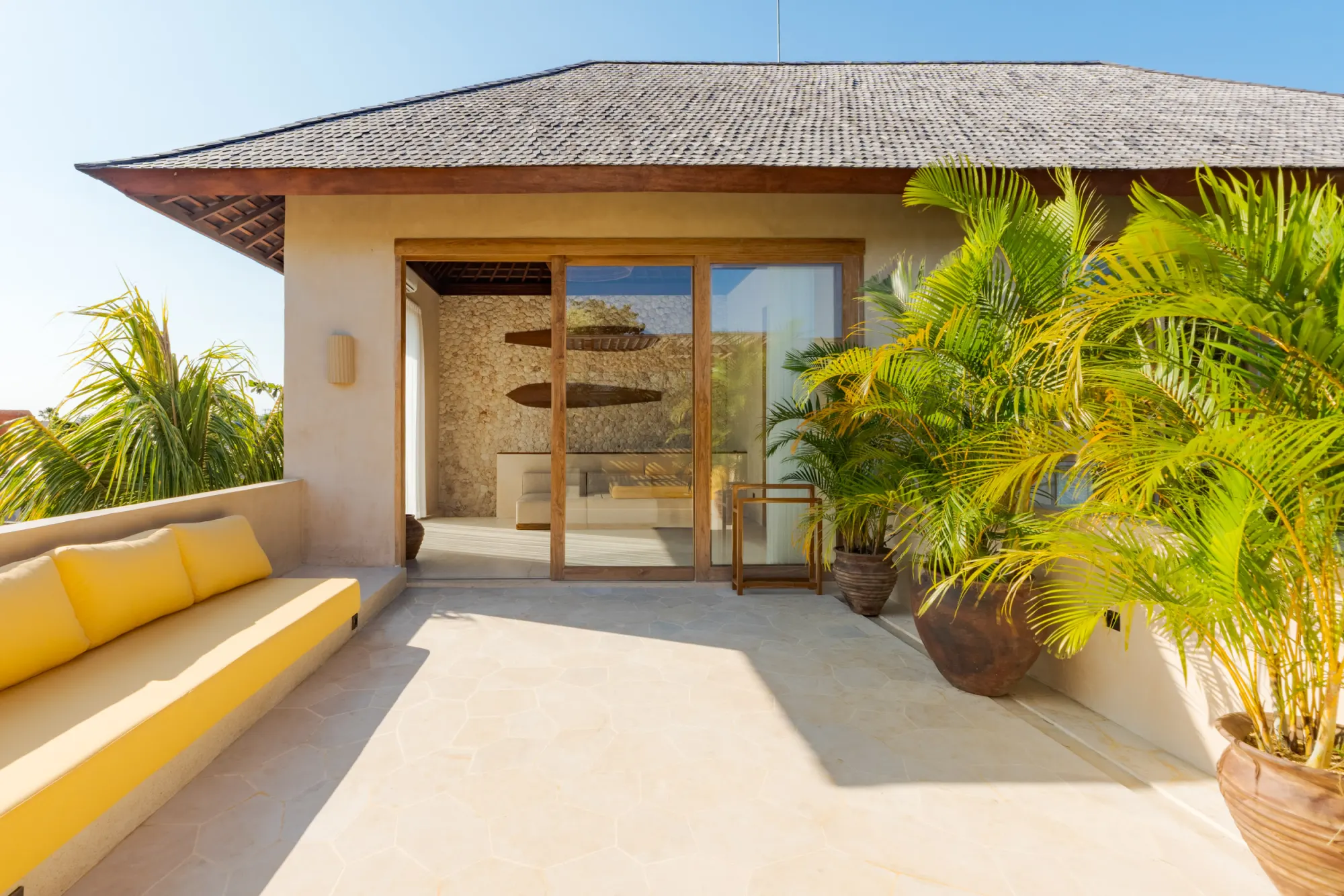 Poolside lounge area with umbrellas and yellow deck seating