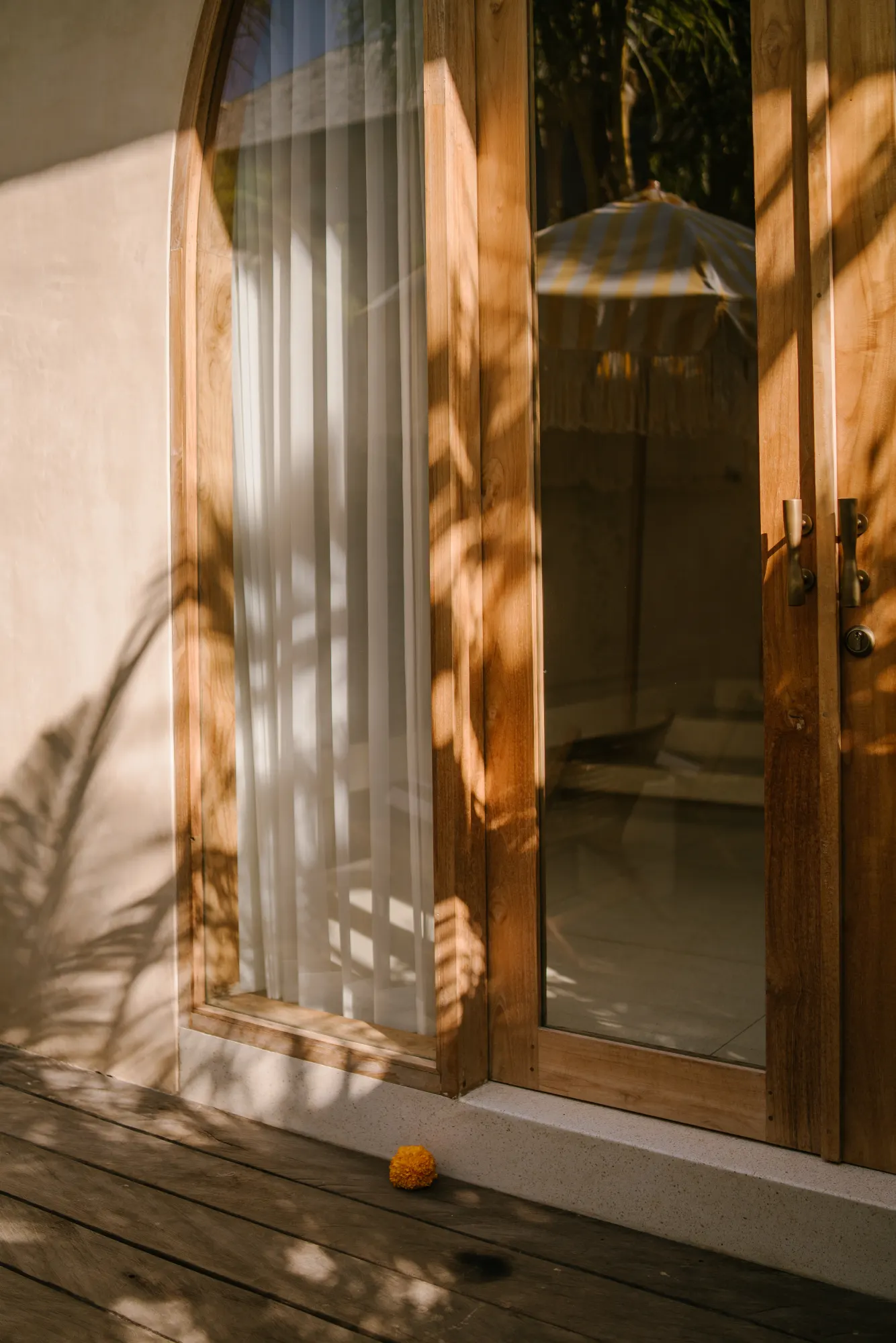 Wooden door with geometric glass panels overlooking garden
