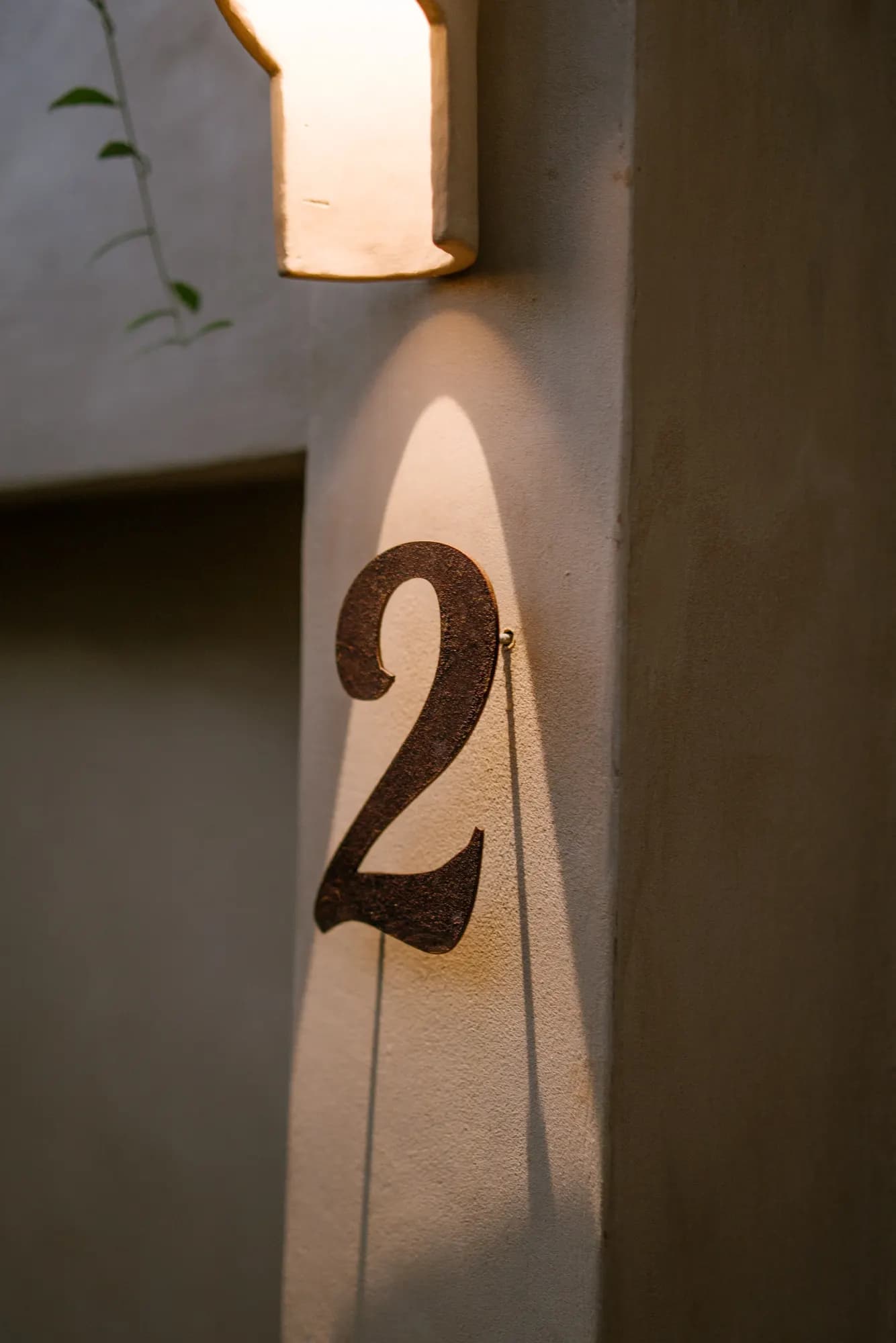 Room number 2 sconce with evening light on wall