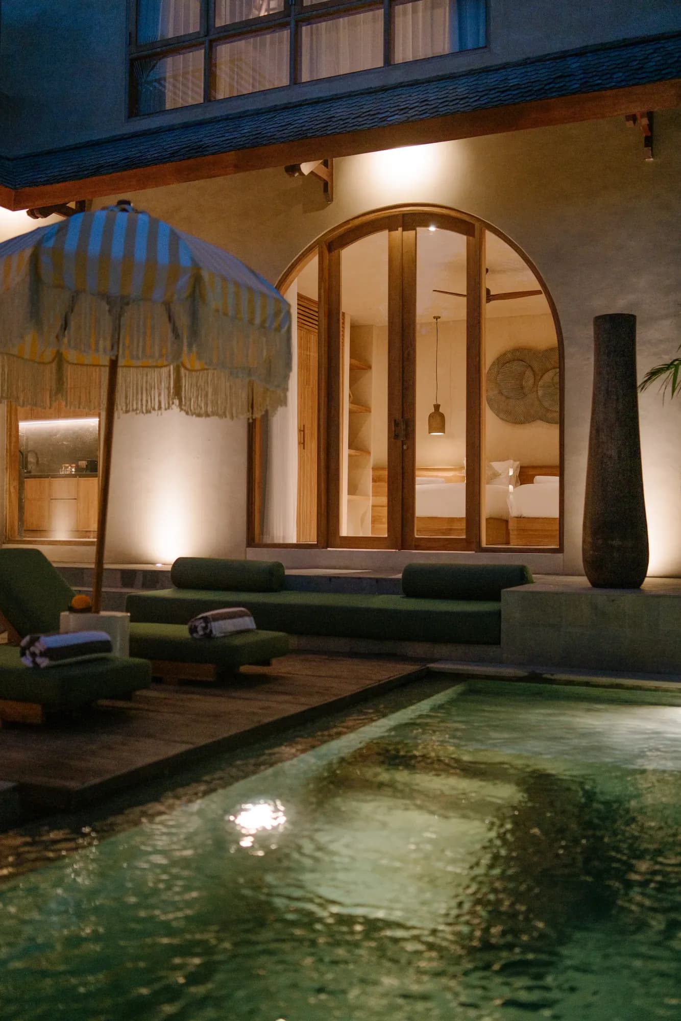 Night view of villa interior through large windows