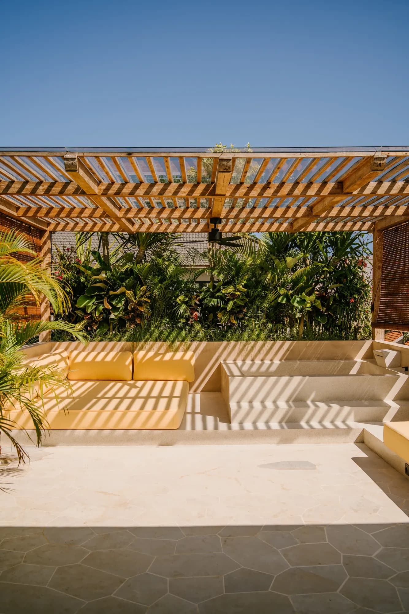 Covered patio with potted plants and lounge seating
