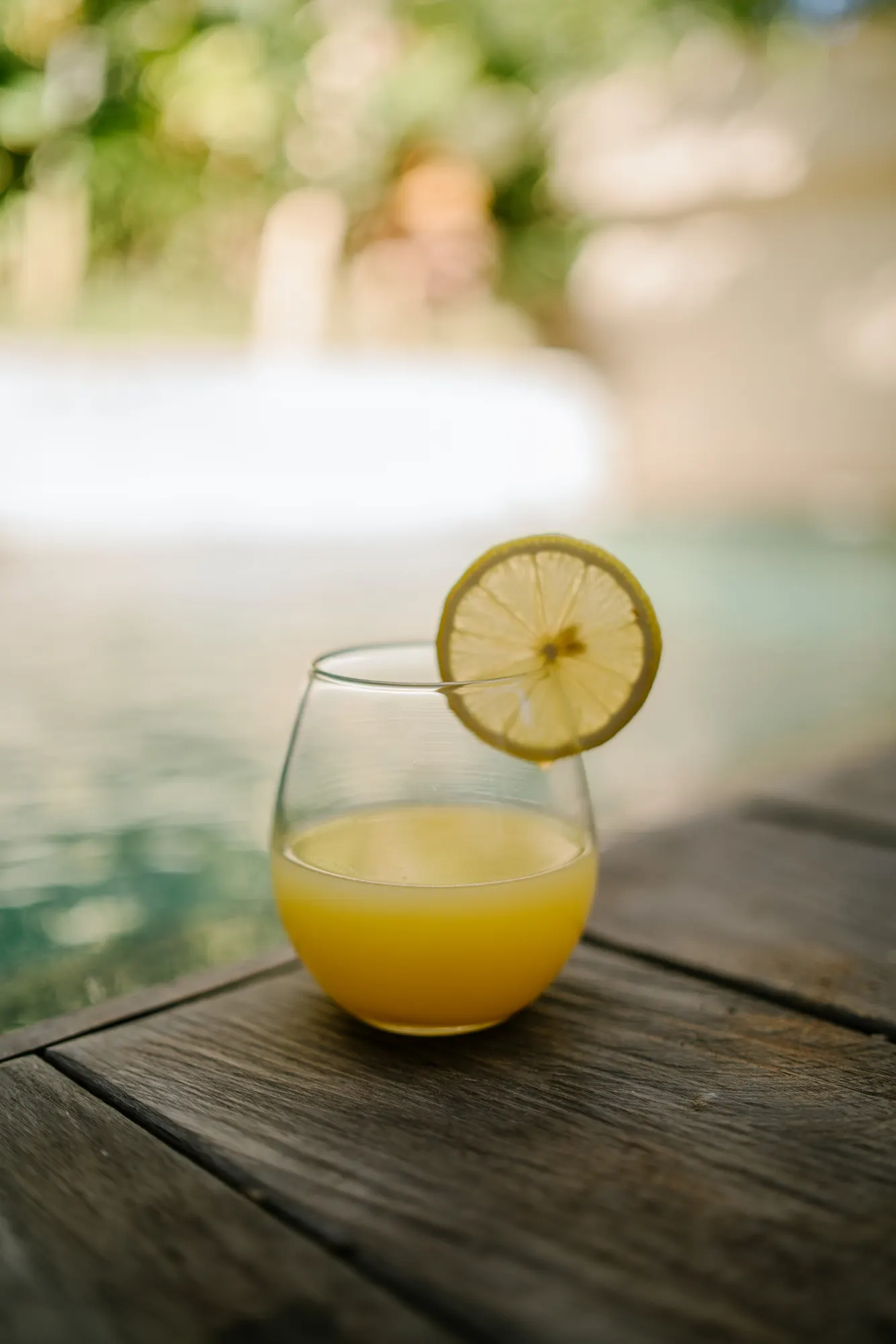 Fresh-squeezed juice with lime slice by the poolside