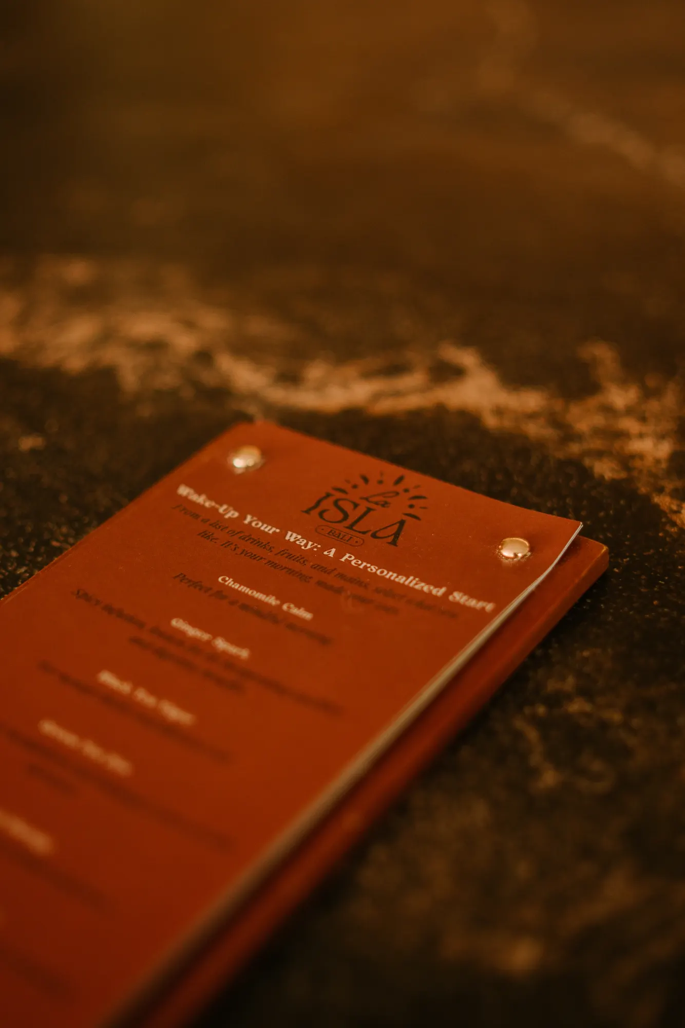 Close-up of a red spa guide book on stone surface