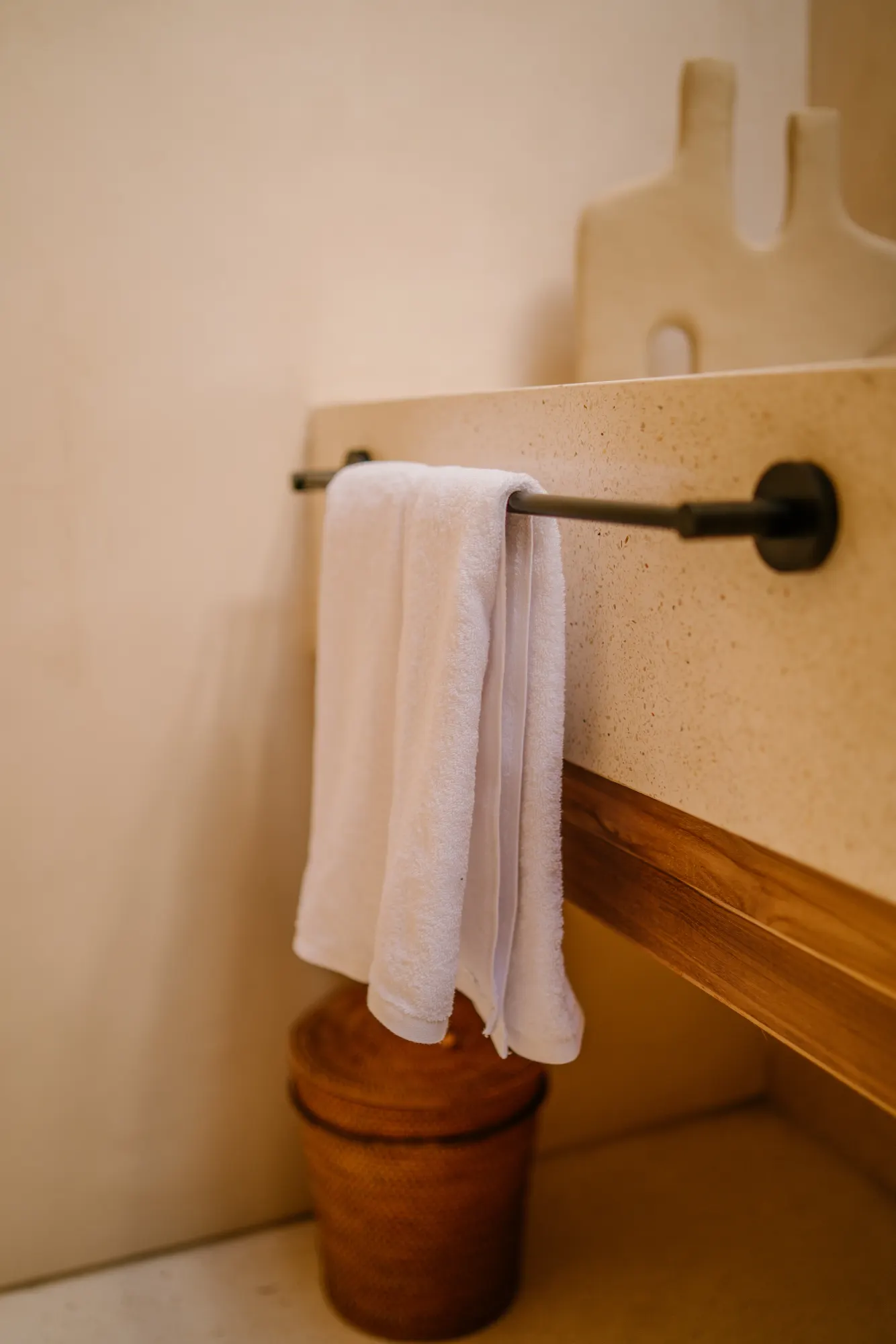 Elegant bathroom detail with towel rack and terrazzo basin