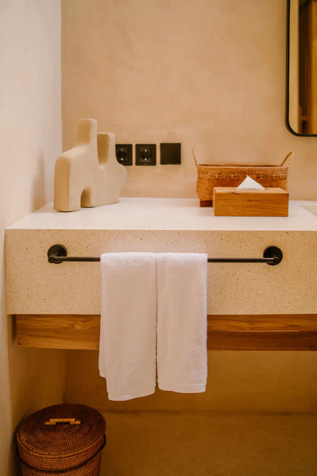 Spa bathroom with decorative vessels and woven storage basket