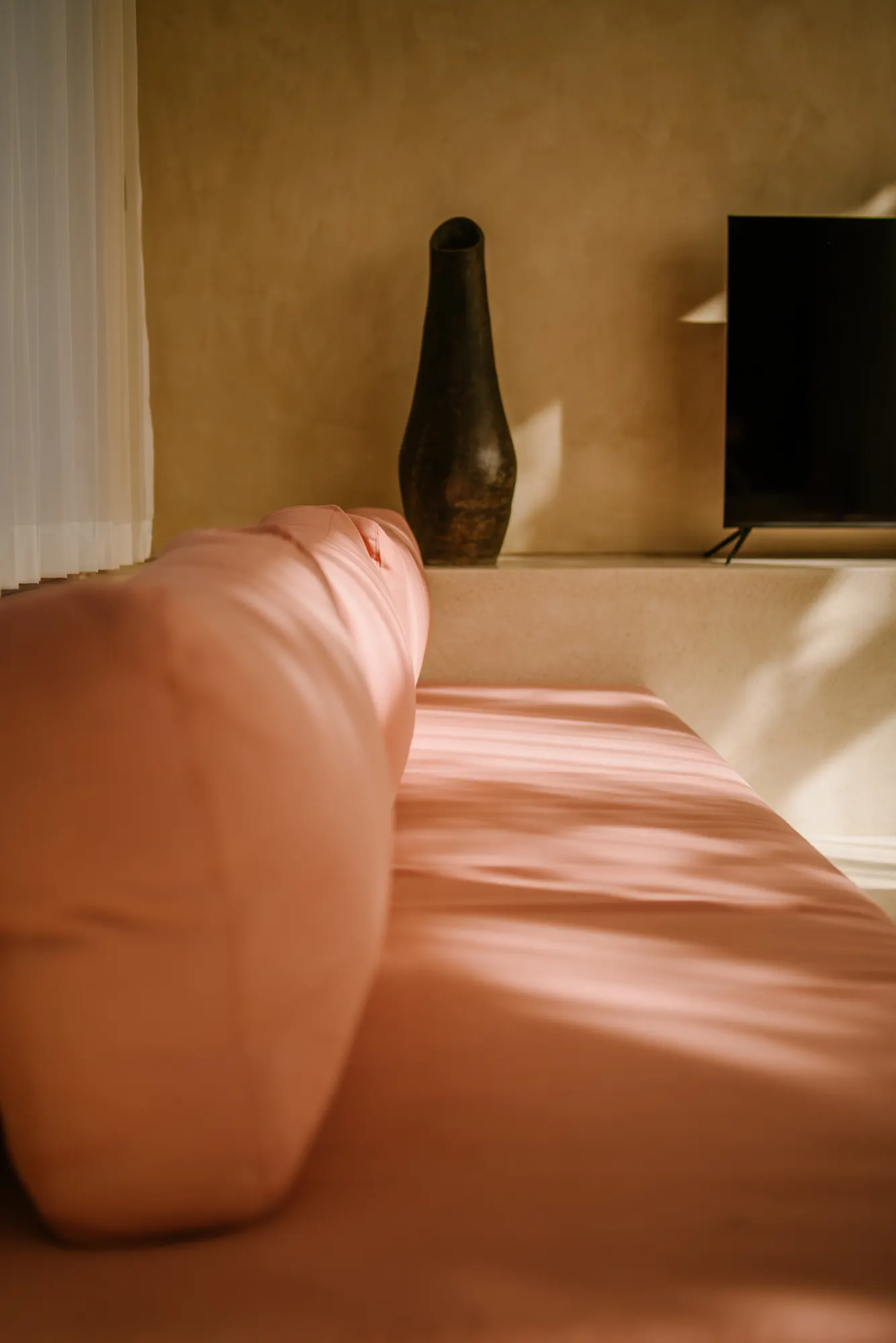 Sculptural wooden bed headpiece as interior design focal point