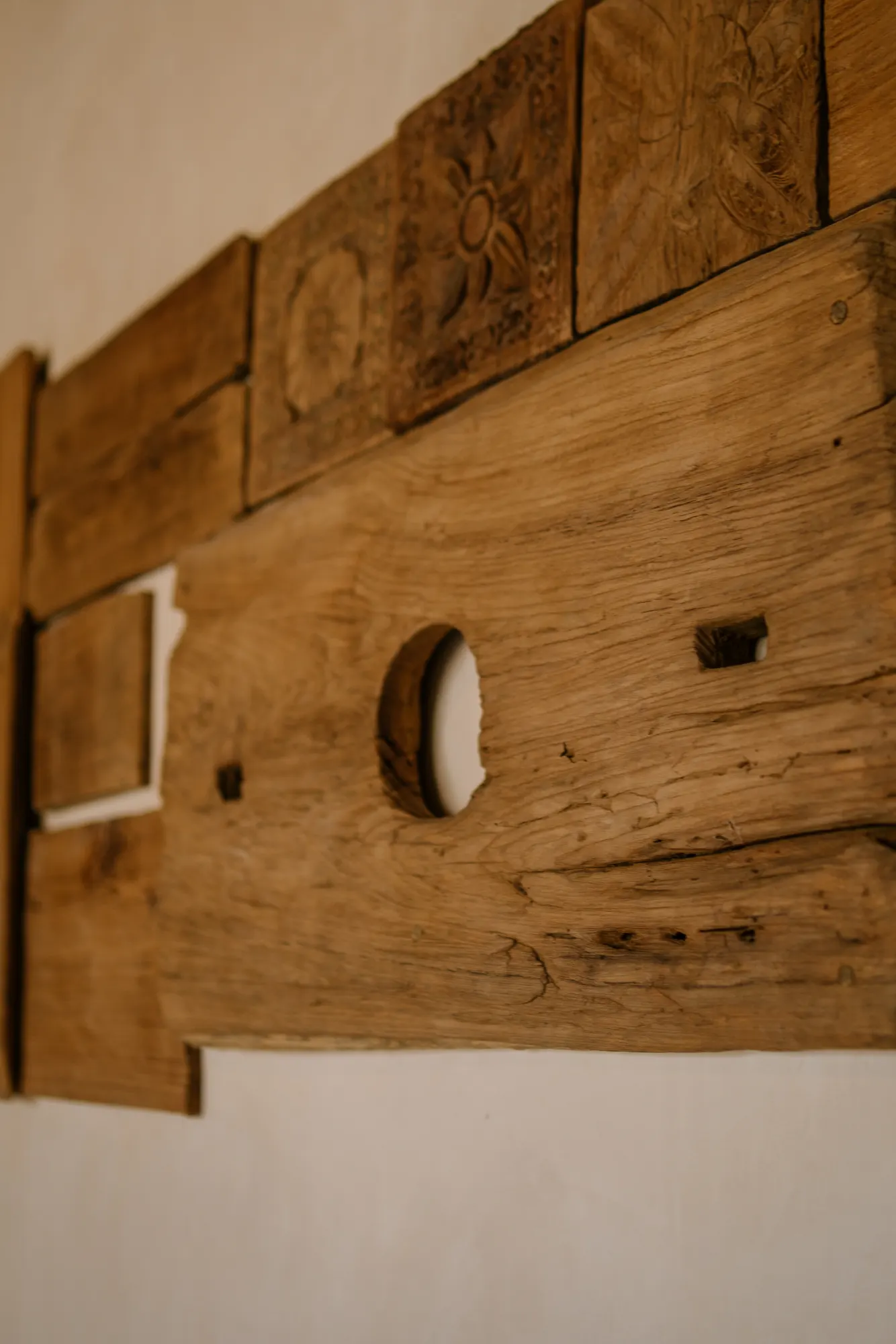 Close-up detail of carved wooden wall art installation