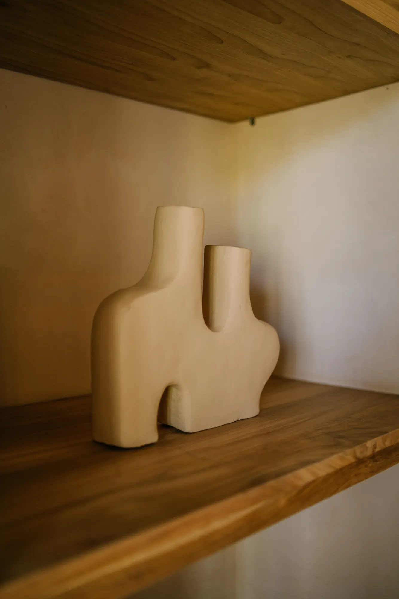 Sculptural wood art pieces displayed on shelves