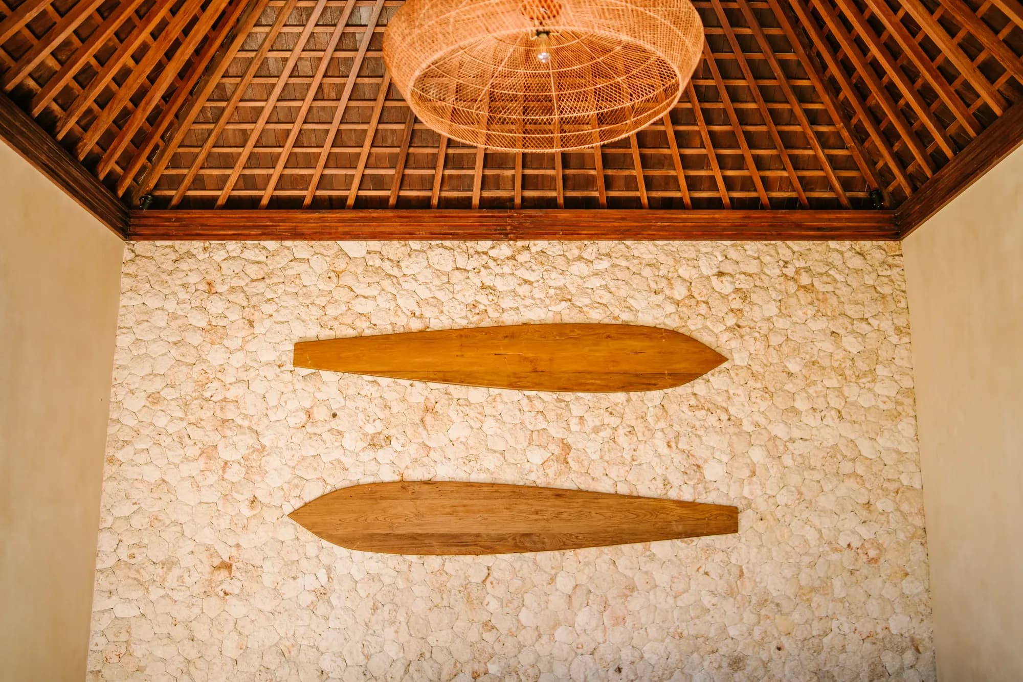Ceiling detail with rattan pendant and artwork display