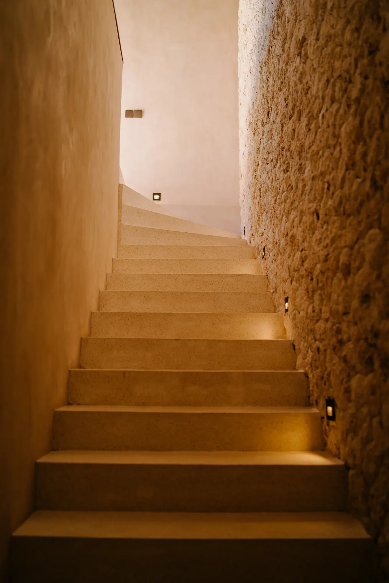 Stairwell ascending with warm architectural lighting