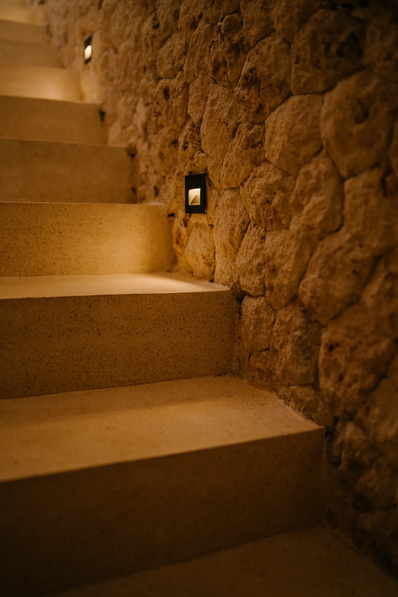 Stone staircase with recessed wall lighting detail