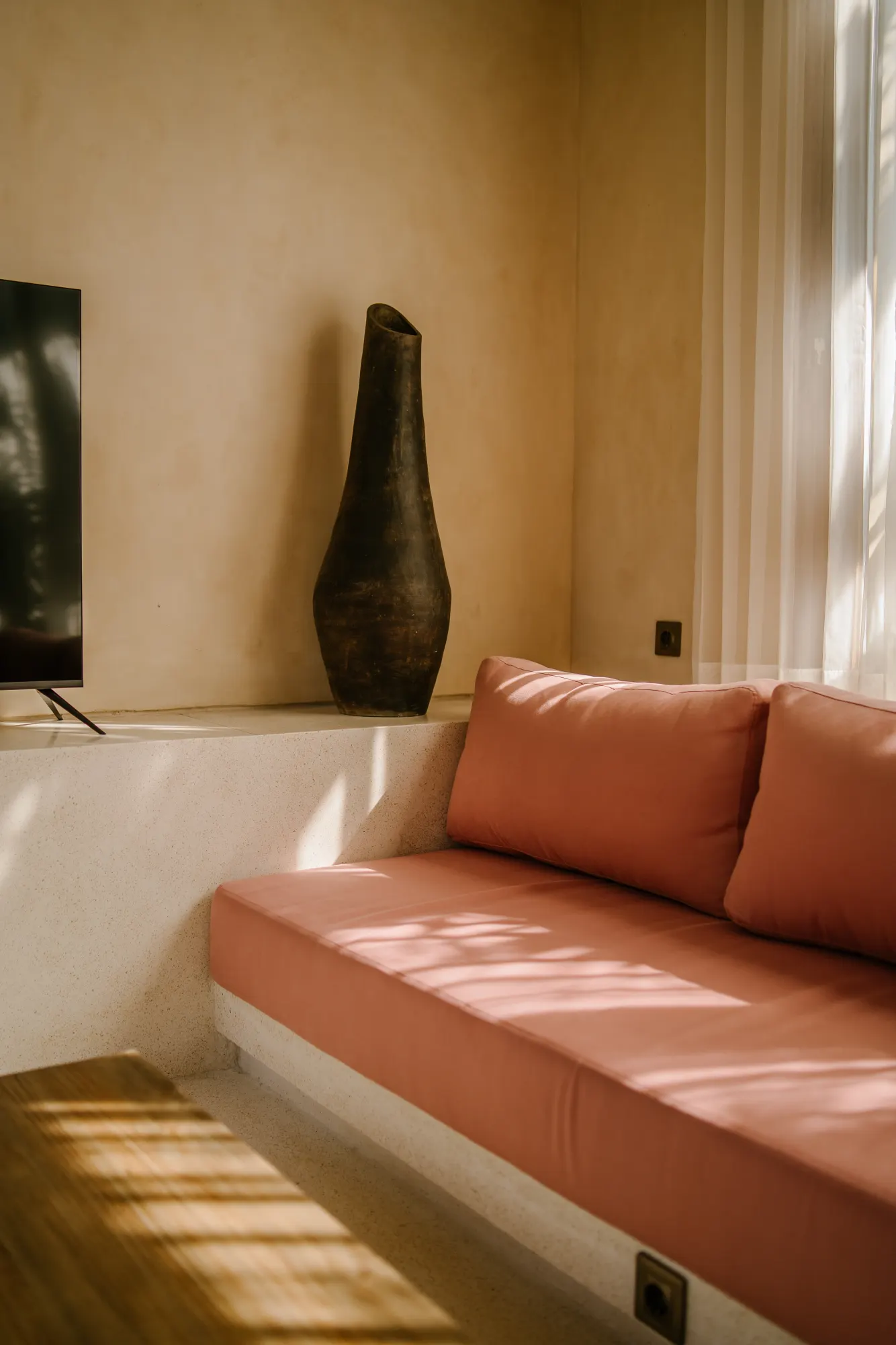 Living room with minimalist seating and vase