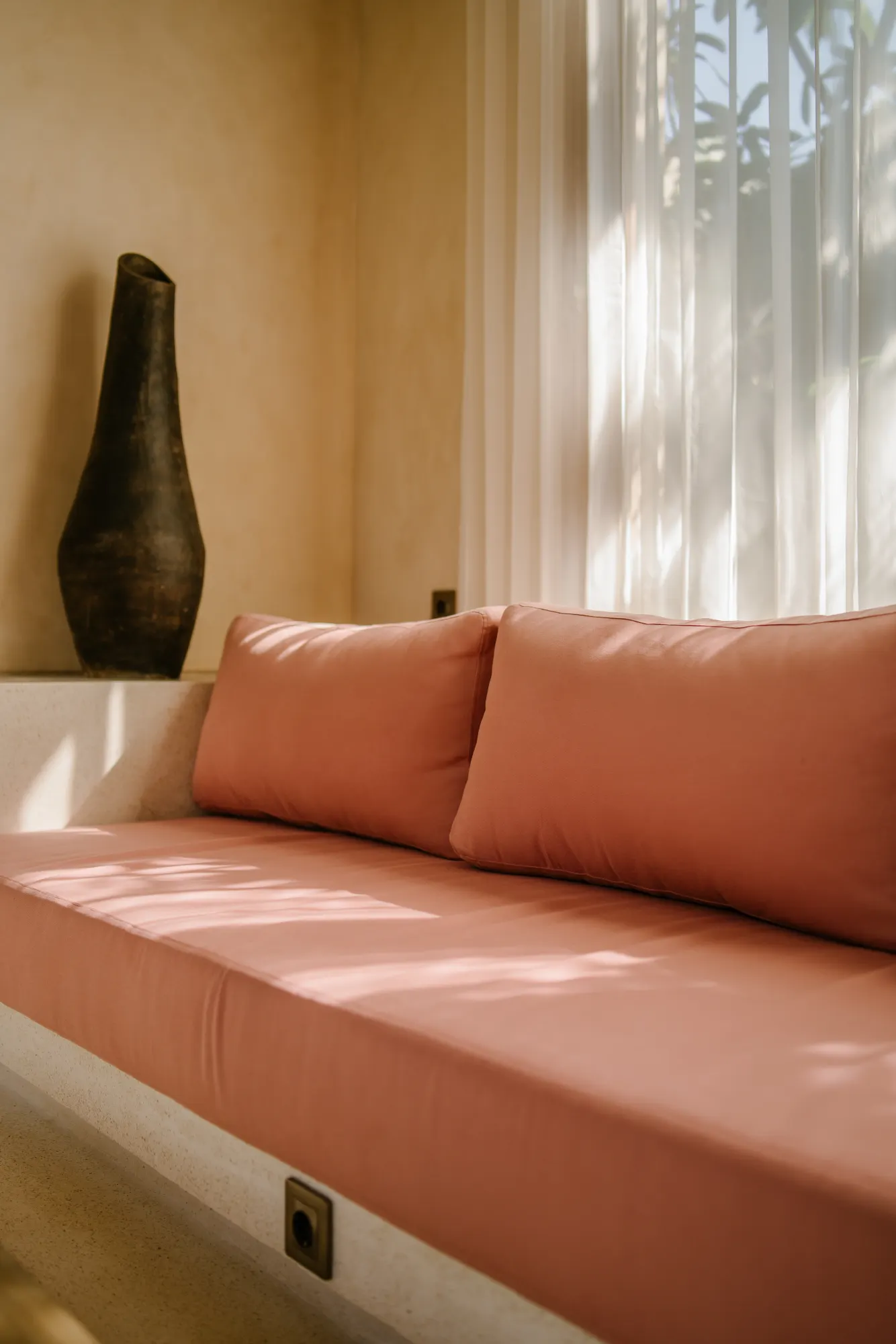 Modern seating area with coral cushions and decor