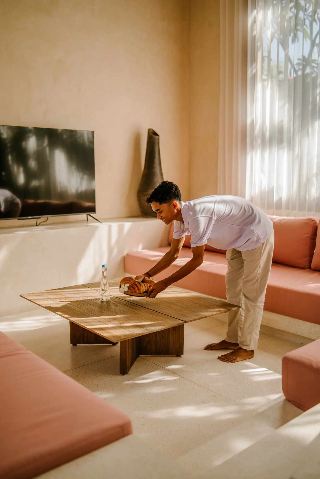Spa room with massage table overlooking garden through windows