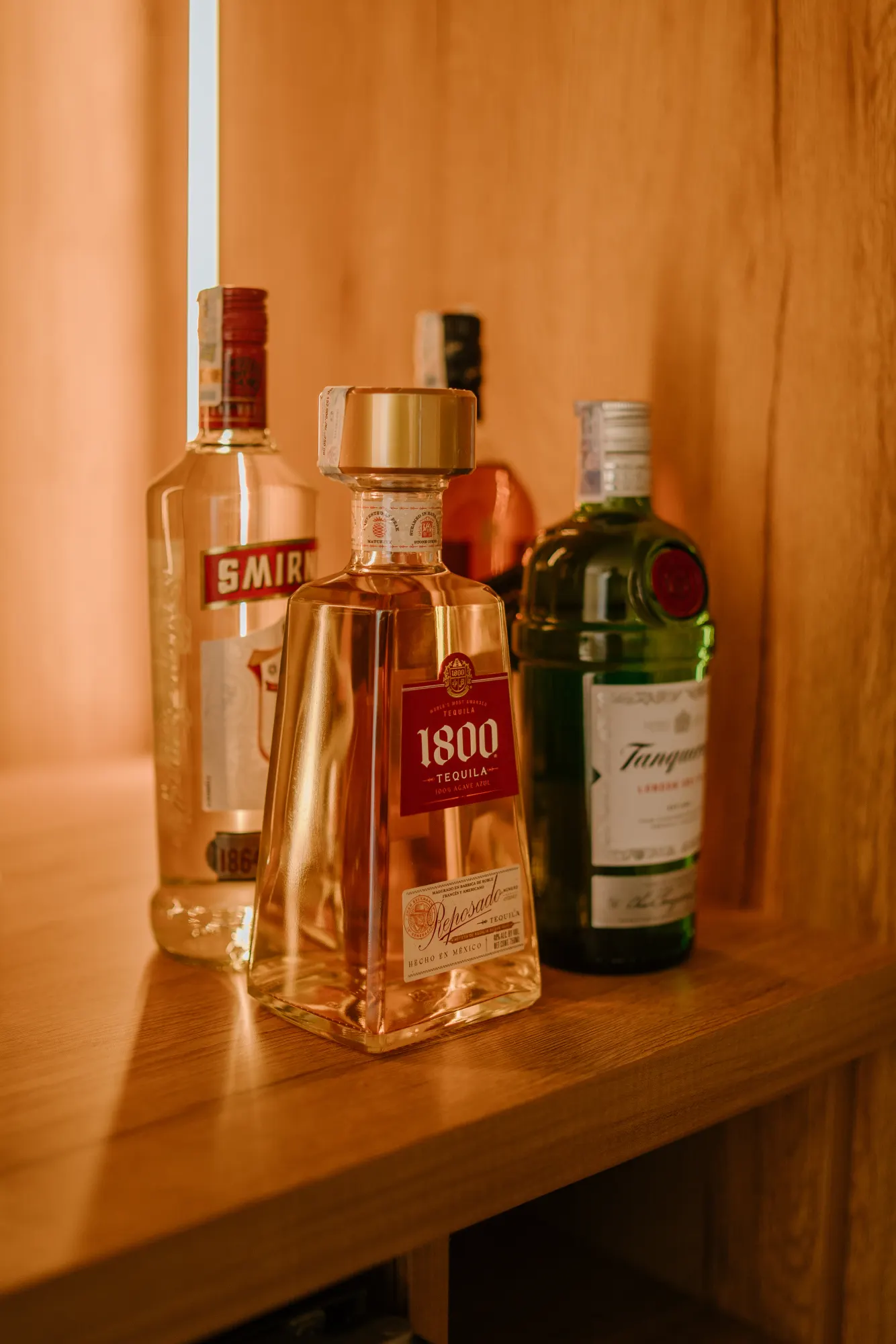 Bar cabinet with wine glasses hanging on rack