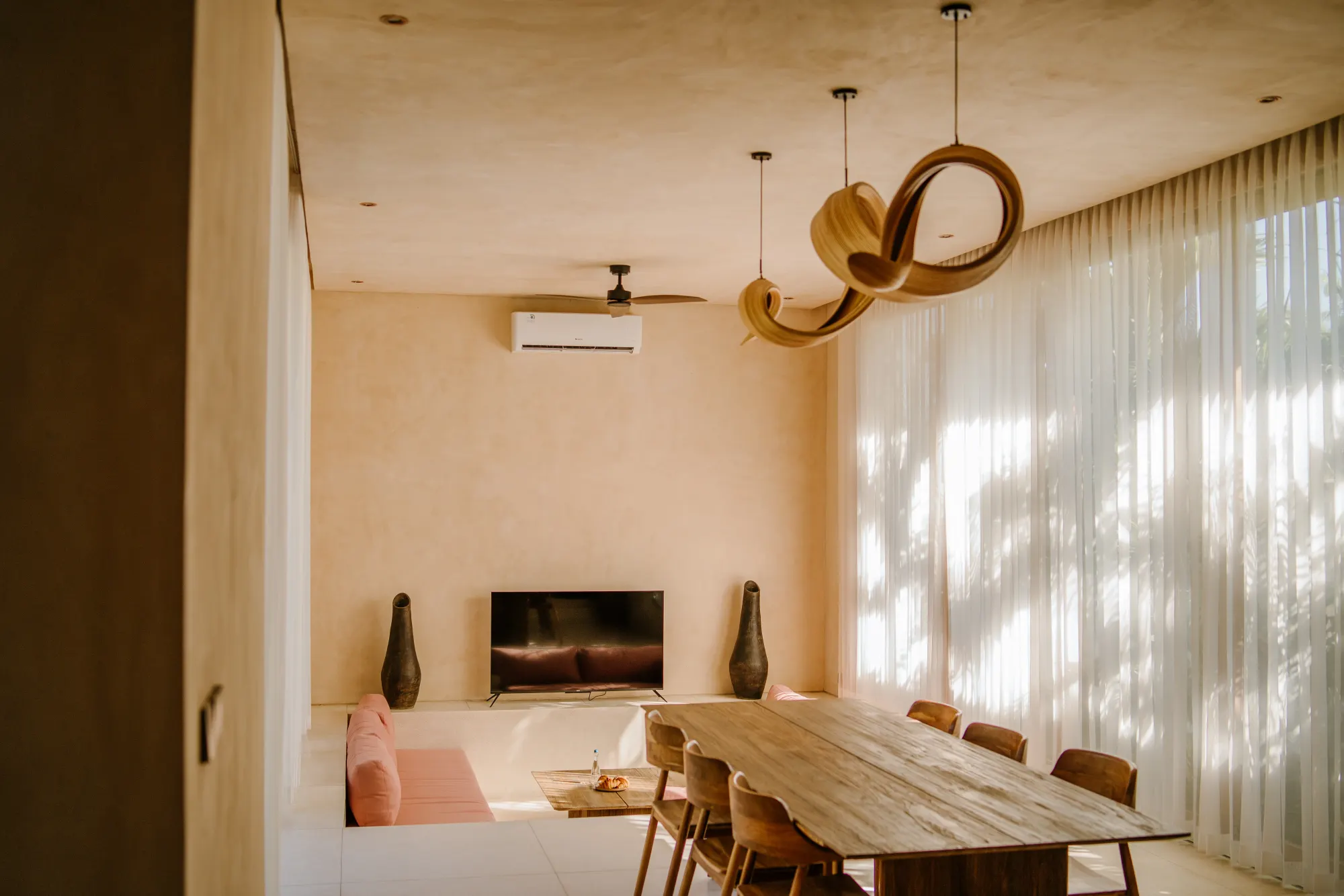 Contemporary dining space with table and wooden chairs