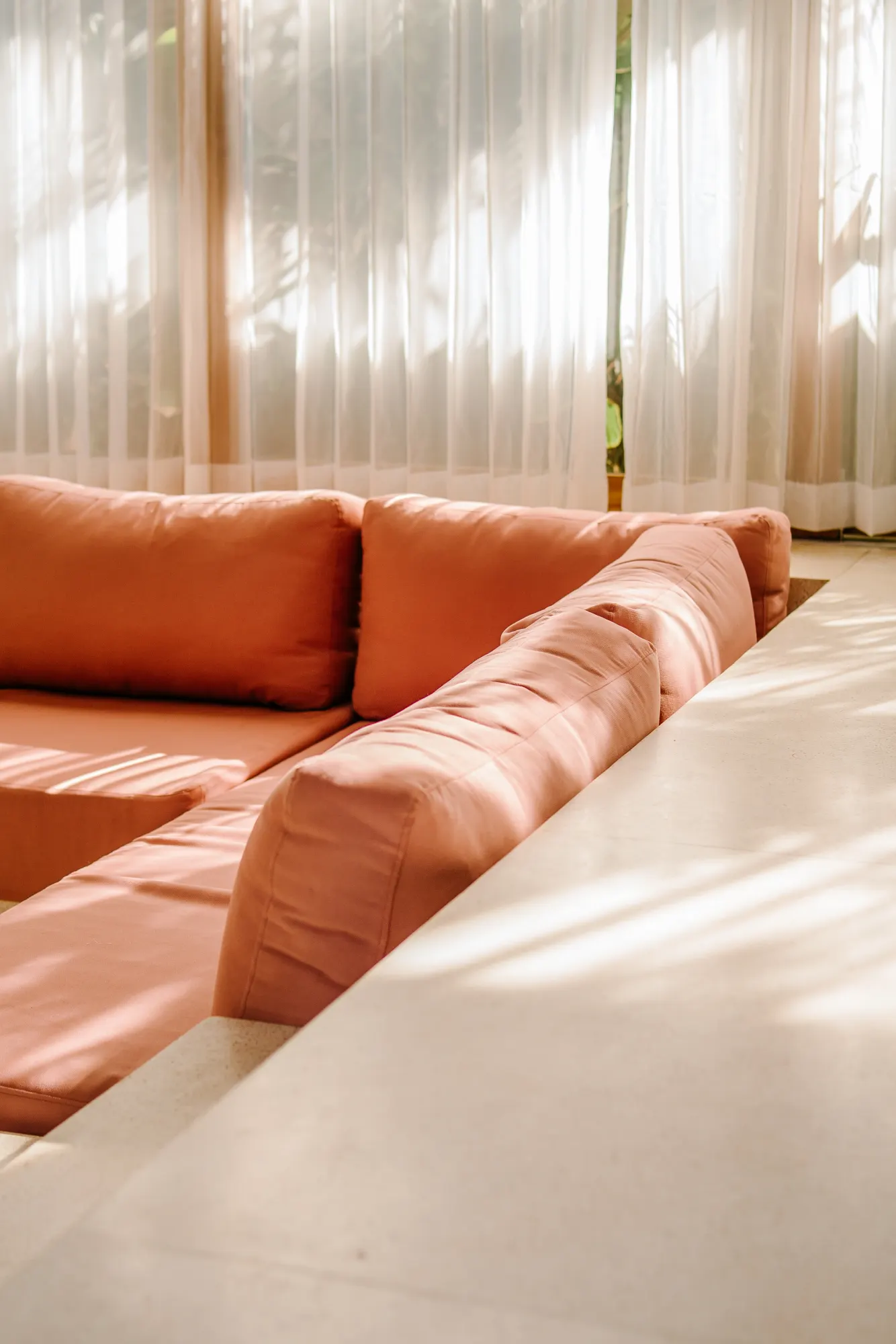 Living room with orange seating and minimalist aesthetic