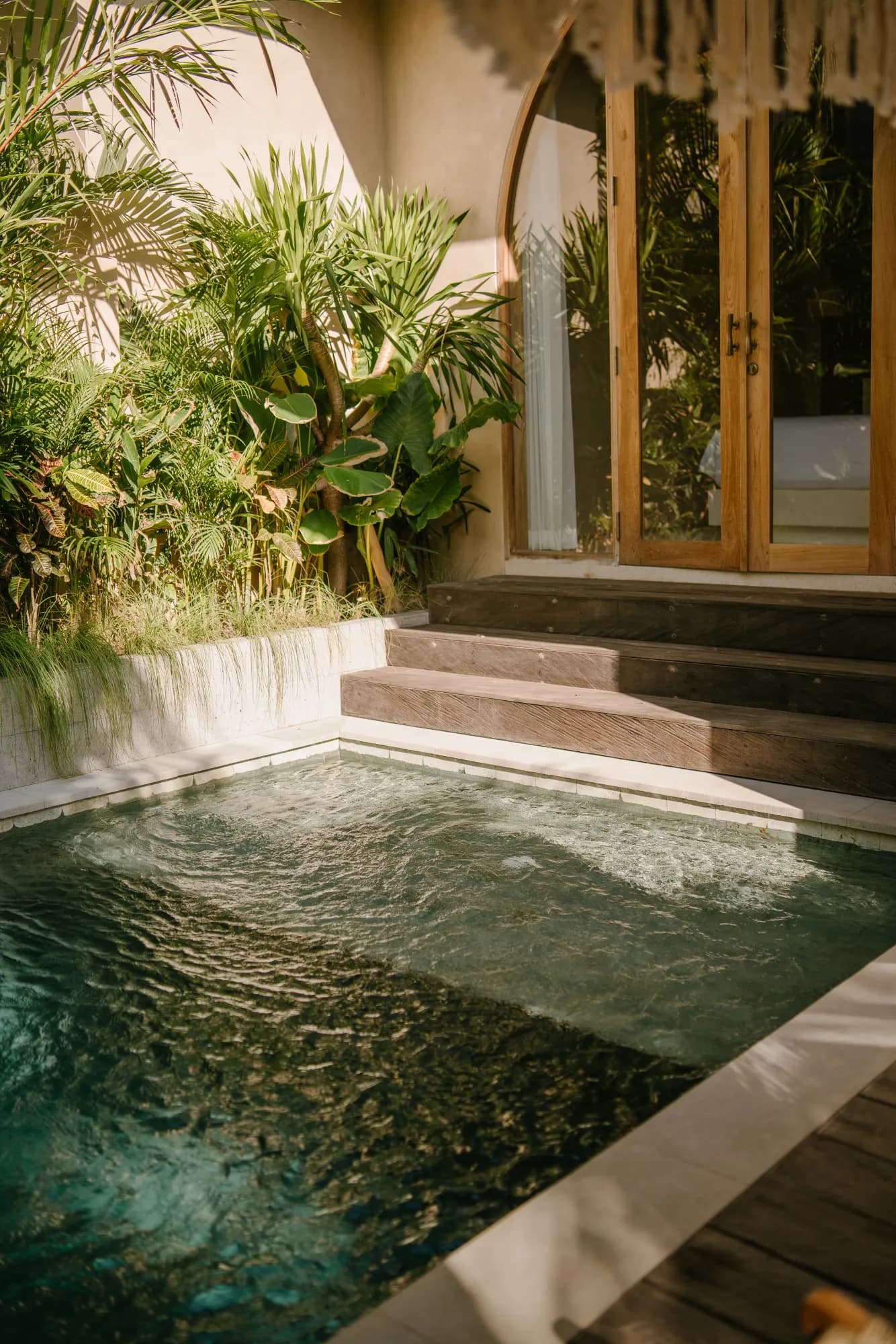 Outdoor water feature with stone edge and landscaping